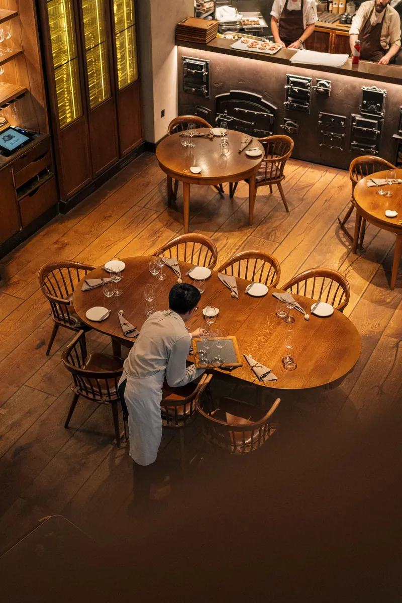 A waiter laying tables in a London bistro