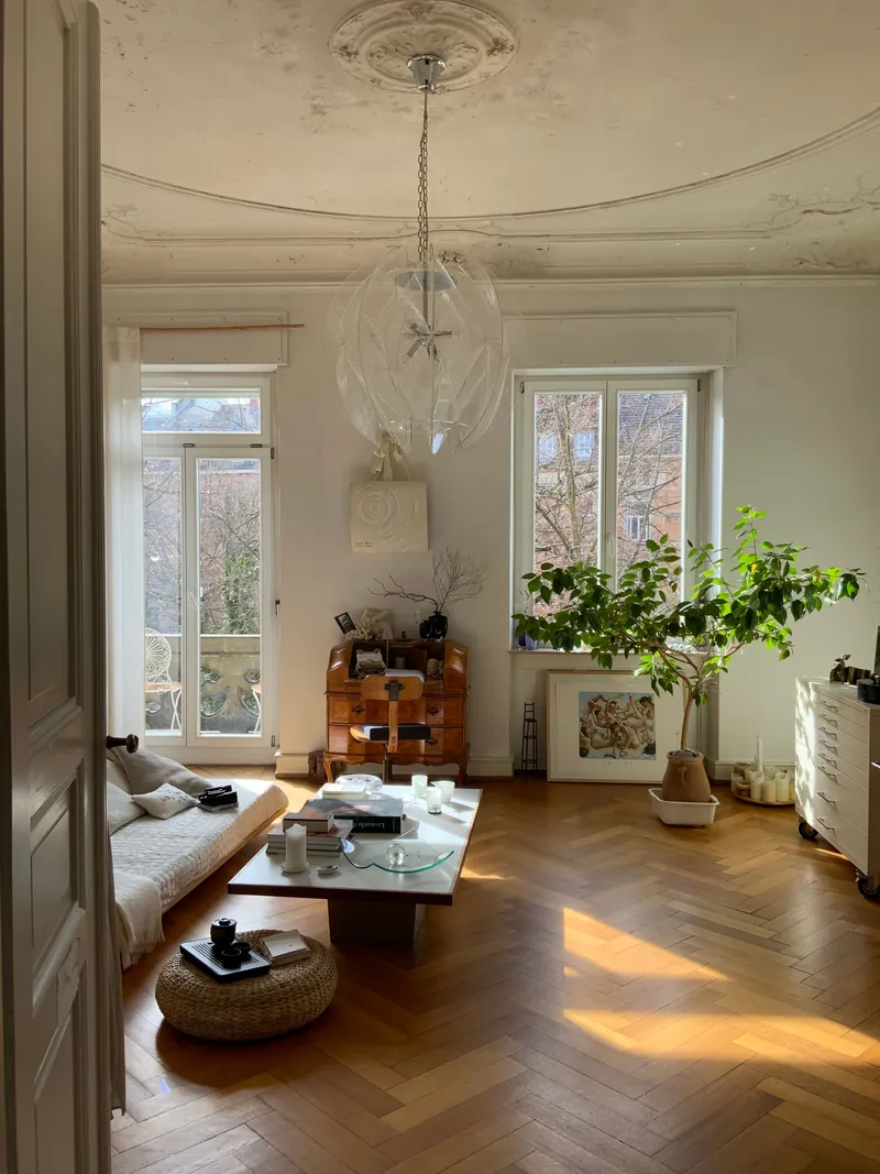 A period sitting room full of plants and light