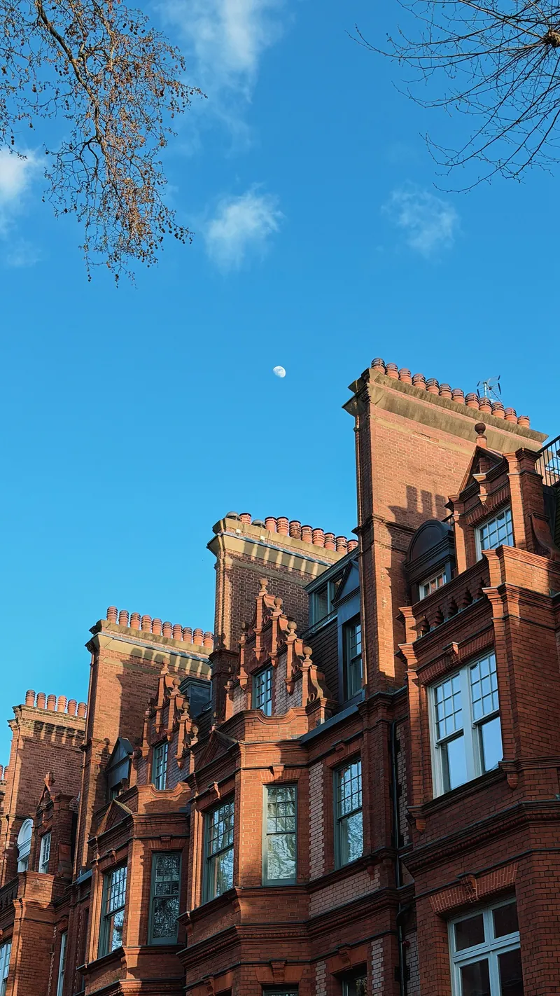 Red brick gables in Chelsea against a blue sky