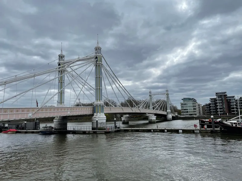 Albert Bridge under a cloudy sky, seen from the river